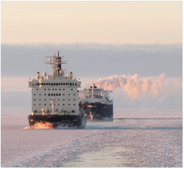 Tanker is lead by icebreaker through norther sea route